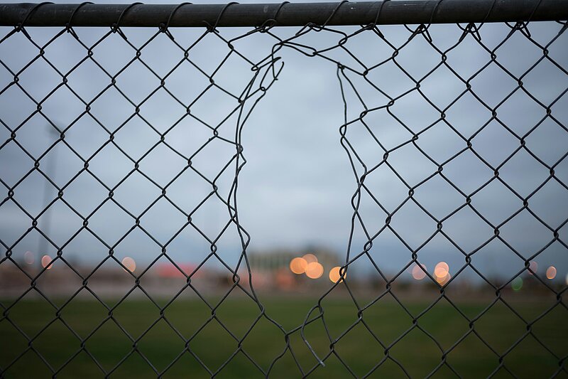Picture of a wire fence with a hole in it
